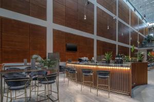 a restaurant with a bar with stools at DoubleTree by Hilton Turin Lingotto in Turin