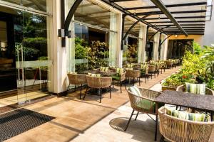 a patio with tables and chairs in a building at DoubleTree by Hilton Nairobi in Nairobi