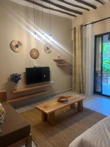 a living room with a coffee table and a tv at Garden Breeze in Bwejuu