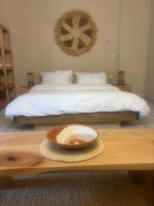 a bed with a plate on a table in a room at Garden Breeze in Bwejuu
