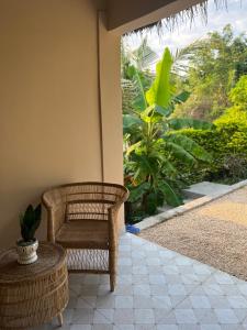 a room with a chair and a table and a window at Garden Breeze in Bwejuu