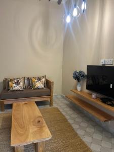 a living room with a couch and a coffee table at Garden Breeze in Bwejuu +9 photos