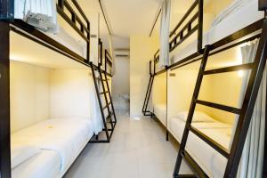 a row of bunk beds in a dorm room at V Canggu Dormitory in Canggu