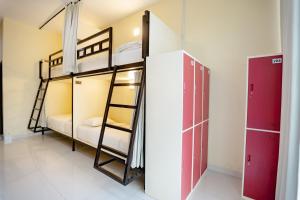 a room with two bunk beds and a closet at V Canggu Dormitory in Canggu