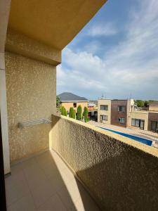 a balcony with a view of a building at Asman Hotel in Bosteri