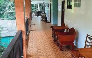 an empty hallway with chairs and tables on a porch at Saikaew Villa in Ko Samed