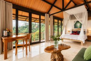 a bedroom in a villa with a bed and a desk at River Song Ubud, Bali in Ubud +77 photos