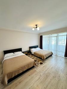 a bedroom with two beds and a window at Asman Hotel in Bosteri +42 photos
