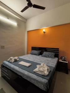 a bedroom with a bed with two towels on it at The Global Nest Homestay 