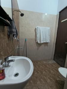 a bathroom with a sink and a shower at The Global Nest Homestay  +21 photos