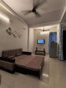 a living room with a bed and a couch at The Global Nest Homestay 
