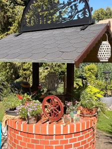 a garden center with a roof on top of a brick wall at Apartment Dietze in Machern