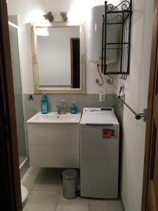 a small bathroom with a sink and a mirror at Ku Wiśle 