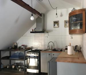 a kitchen with a sink and a stove at Ku Wiśle 