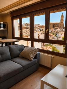 a living room with a couch and a view of a city at Conde de Lerín by Clabao in Lerín