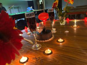 a table with a cake and two glasses of champagne at Kalasita in Mahabaleshwar