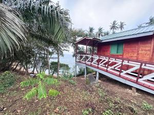 a house on a hill next to the ocean at Conjá Ecolodge in Porto Alegre