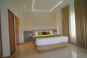 a bedroom with a bed in a room at Grace Residency in Sultan Bathery
