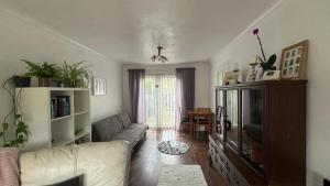 a living room with a couch and a tv at Koti in Murton