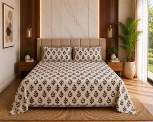 a bedroom with a bed with a blanket and pillows at Hotel teara in Gwalior