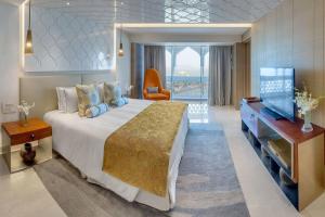 a hotel room with a large bed and a desk at Hotel teara in Gwalior