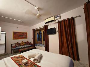 a bedroom with a bed and a couch in it at Third eye view hotel and hostel in Jaisalmer