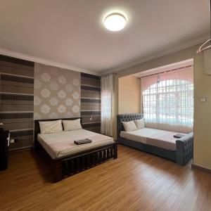 a bedroom with two beds and a window at Homestay by Tas in Kulai