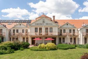 a hotel with solar panels on the roof at Ametiszt Hotel Harkány in Harkány