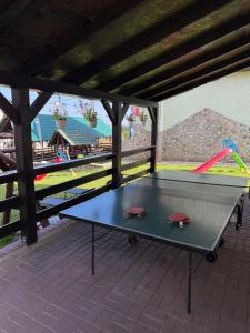 a ping pong table sitting on top of a patio at Casa Verde in Ranca