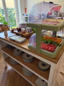 a shelf with food on top of a table at Szumi Las Bed & Breakfast in Józefów +82 photos