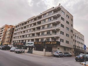a large building with cars parked in front of it at فندق هدب - المربع in Riyadh