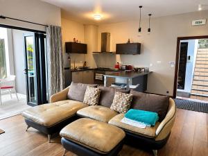 a living room with a couch and a kitchen at Pingo Premium in La Gaulette