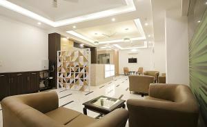 a living room with two couches and a tv in a room at Hotel Apple Park - Near Delhi Airport, Free Airport Trasnfer in New Delhi
