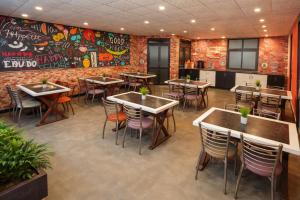 a restaurant with tables and chairs and a brick wall at Hotel Apple Park - Near Delhi Airport, Free Airport Trasnfer in New Delhi