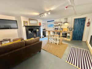 a living room with a couch and a table and a kitchen at Albert Road Flat 4 in Colne