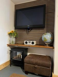 a living room with a television and a fireplace at Albert Road Flat 4 in Colne