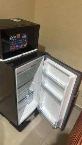 an open refrigerator with a box on top of it at Casa Victoria in Colima