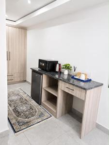 a kitchen with a counter top with a microwave at Cleopatra Palace in Vereeniging