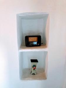 a plastic box with a cell phone in it at The Priest House in Makrotándalon