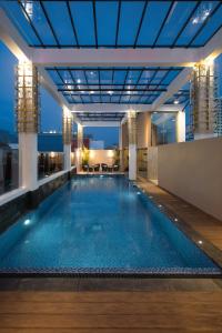 a large swimming pool on the roof of a building at Hotel Chanti Managed by TENTREM Hotel Management Indonesia in Semarang