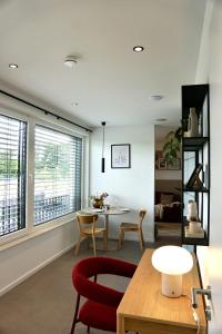 a living room with a red chair and a table at SmartStay in Gronau