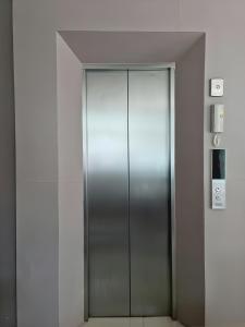 a elevator with a metal door in a building at Sitara Patong Beach in Patong Beach