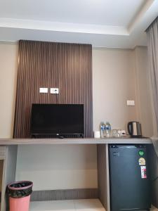 a desk in a hotel room with a television at Sitara Patong Beach in Patong Beach +29 photos