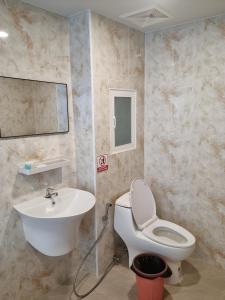 a bathroom with a white toilet and a sink at Sitara Patong Beach in Patong Beach