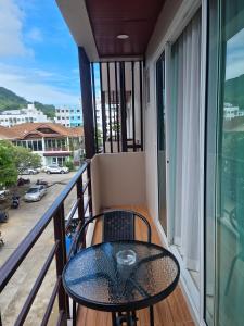 a balcony with a table and chairs on it at Sitara Patong Beach in Patong Beach