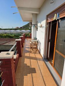 a patio with tables and chairs on a building at Villa Greku in Dushnik