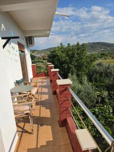 a balcony with tables and chairs on a building at Villa Greku in Dushnik