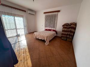 a bedroom with a bed and a window and a chair at Villa Greku in Dushnik +7 photos