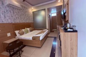 a hotel room with a bed and a television at FabHotel Maitree Beach Resort in Arambol