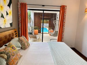 a bedroom with a bed and a view of a pool at Pingo Premium in La Gaulette +49 photos